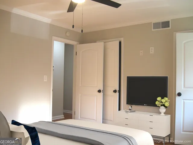a bedroom with a bed and a chandelier
