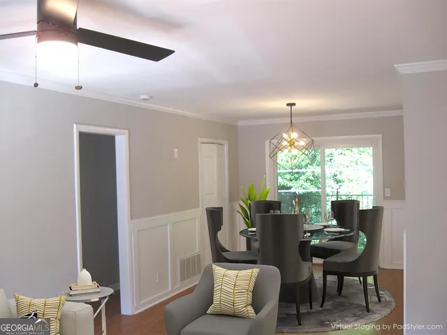 a view of a livingroom with furniture and a large window