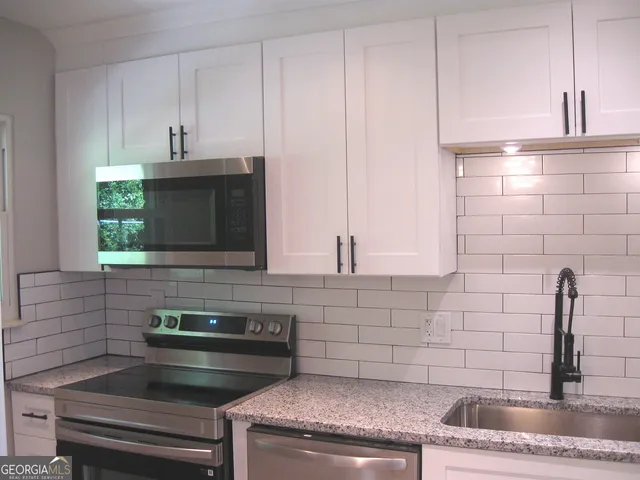 a kitchen with a sink and cabinets