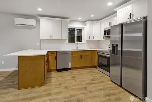 a kitchen with kitchen island a refrigerator sink and microwave