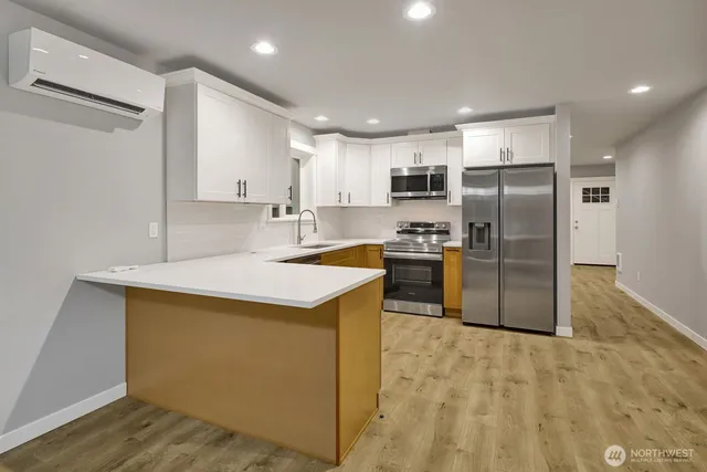 a kitchen with stainless steel appliances granite countertop a refrigerator sink and stove