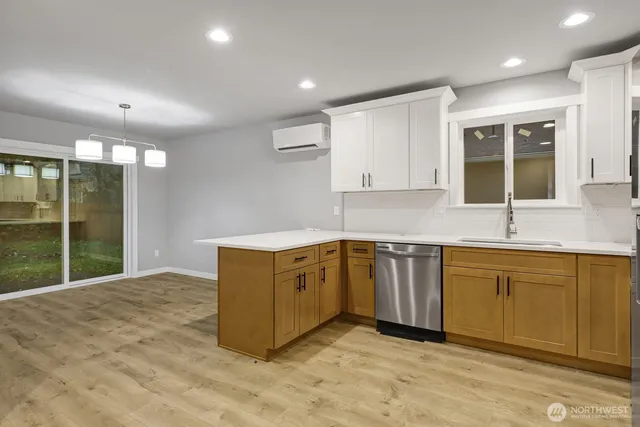 a kitchen with a refrigerator sink and cabinets