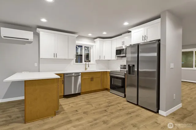 a kitchen with stainless steel appliances granite countertop a refrigerator sink and cabinets
