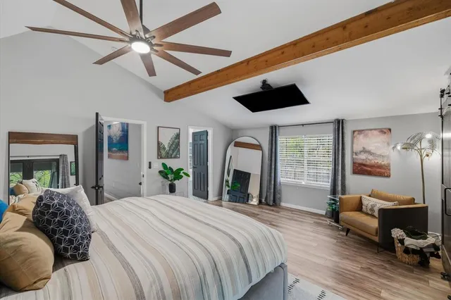 a bedroom with a large bed a large window with the outer view