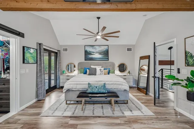 a bathroom with a sink a toilet a mirror and shower