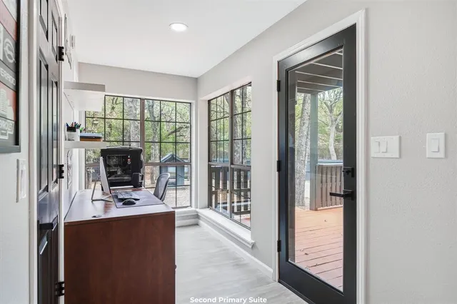 a spacious bedroom with a bed and glass window