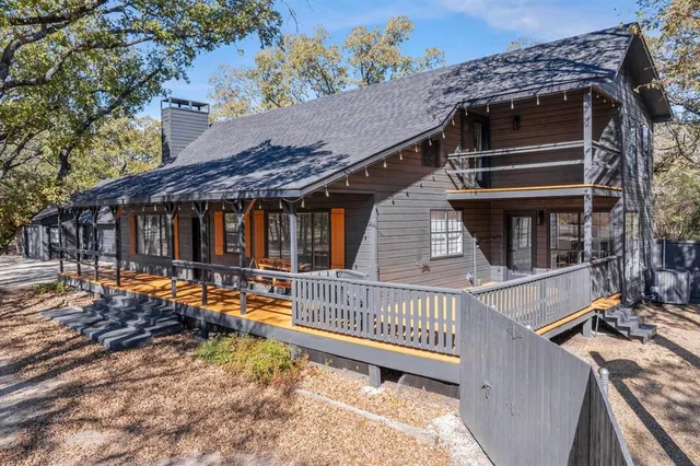 a view of a house with a deck and a yard