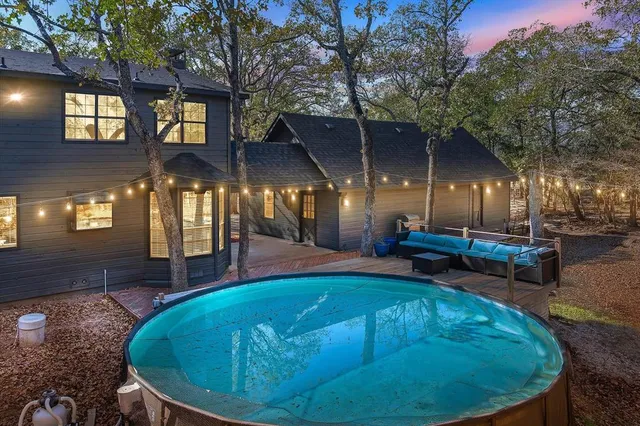 a swimming pool with outdoor seating and yard