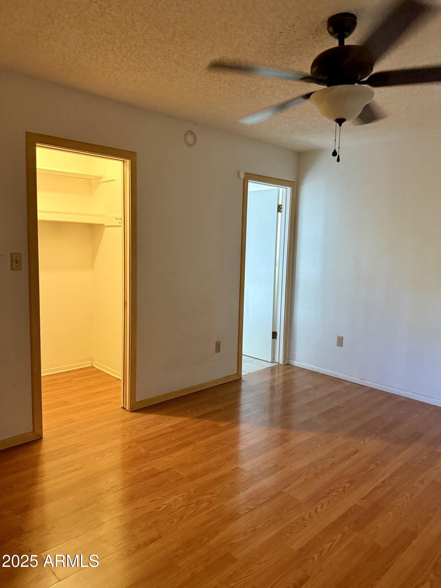 5856 Colby Street Mesa, AZ 85205 - Photo 11 of 18 a view of an empty room with wooden floor