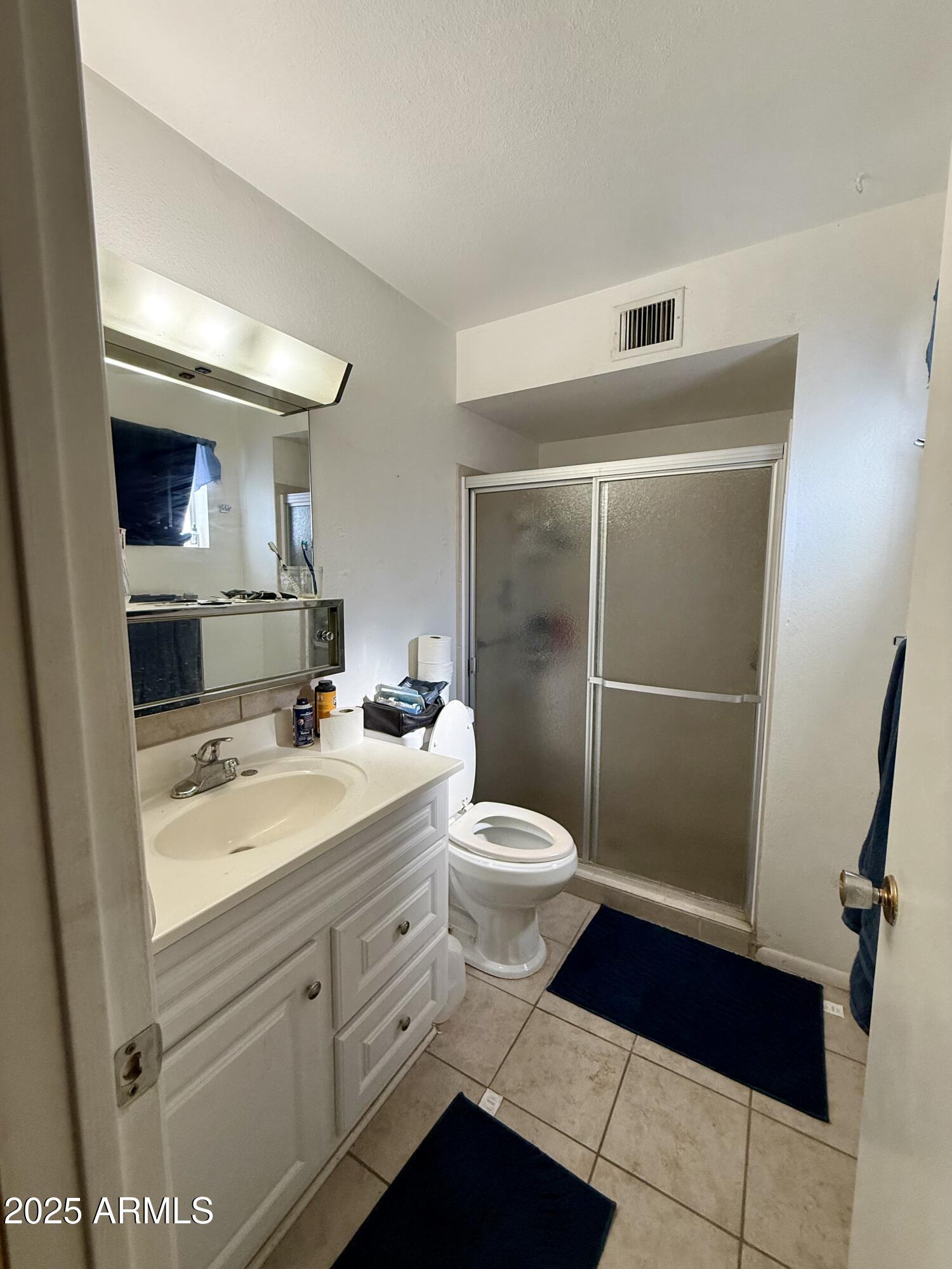 5856 Colby Street Mesa, AZ 85205 - Photo 12 of 18 a bathroom with a toilet a sink and mirror
