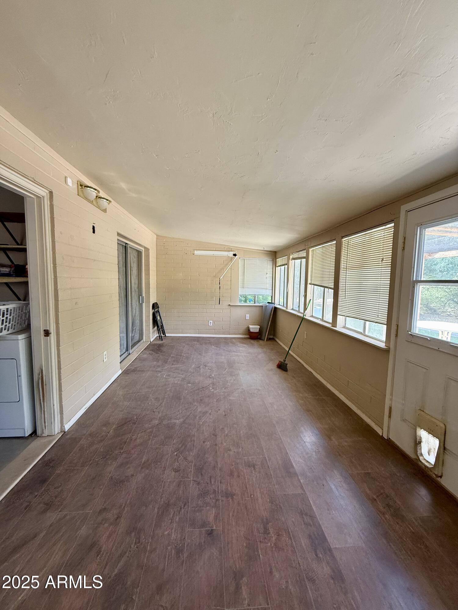 5856 Colby Street Mesa, AZ 85205 - Photo 15 of 18 a view of an empty room with a window and wooden floor