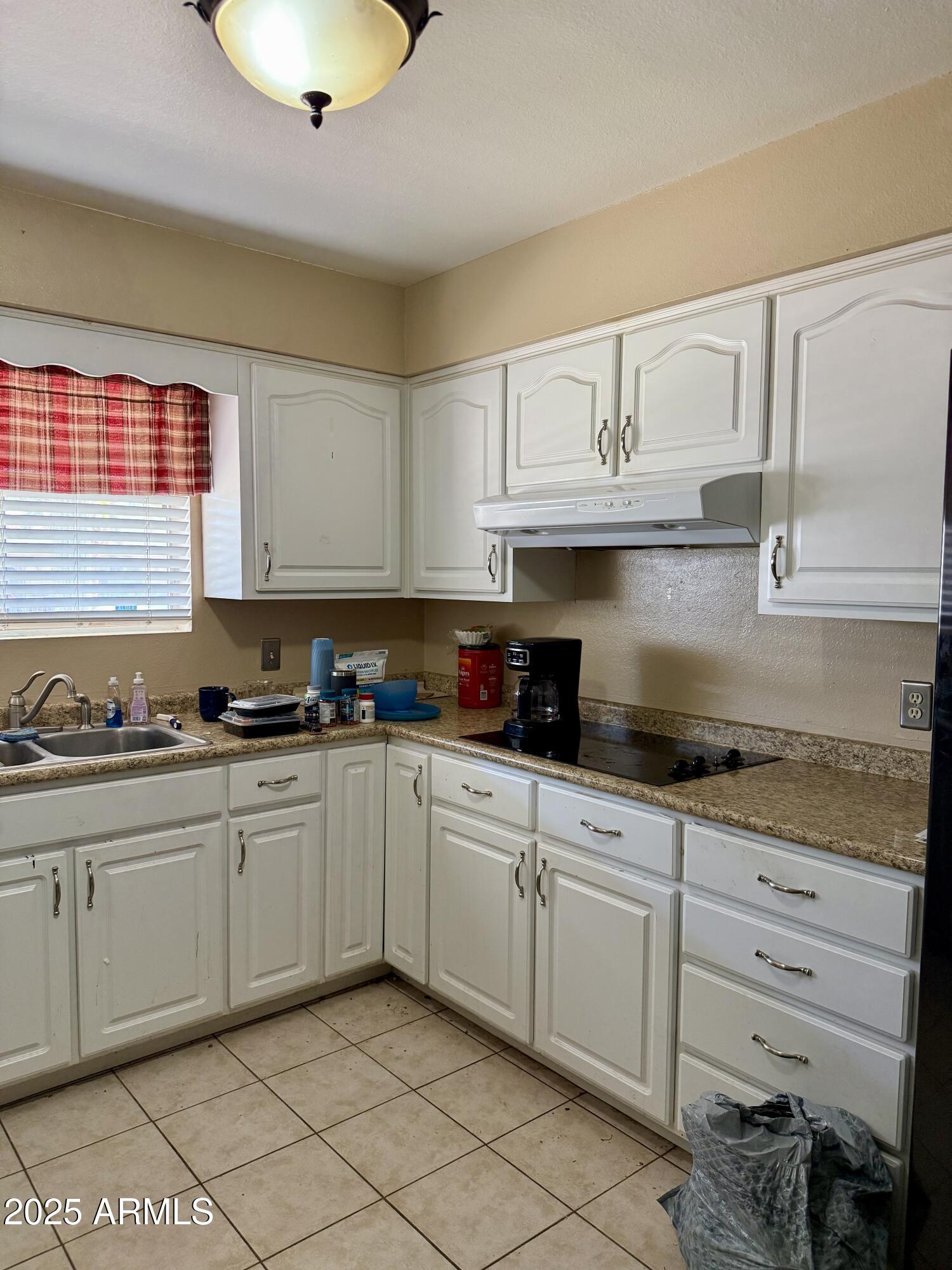 5856 Colby Street Mesa, AZ 85205 - Photo 6 of 18 a kitchen with granite countertop white cabinets and white appliances