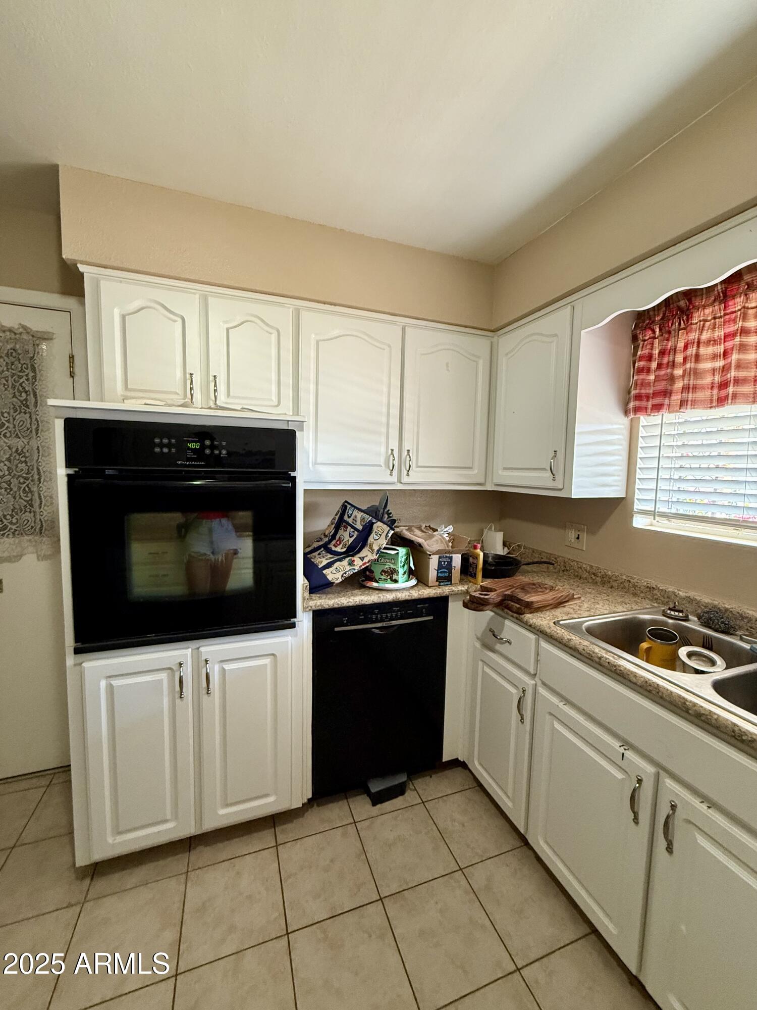 5856 Colby Street Mesa, AZ 85205 - Photo 7 of 18 a kitchen with stainless steel appliances a stove a microwave a sink and cabinets