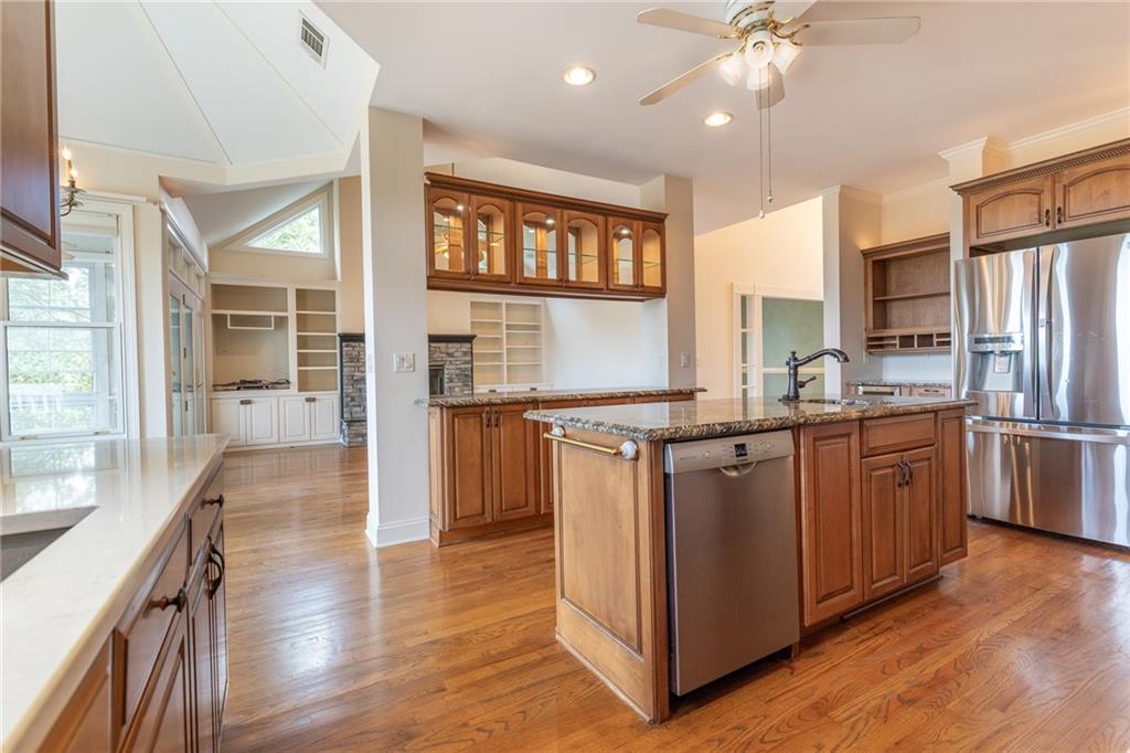 5739 Ridgewater Circle Gainesville, GA 30506 - Photo 33 of 93 a kitchen with stainless steel appliances granite countertop a refrigerator a stove and a wooden floors