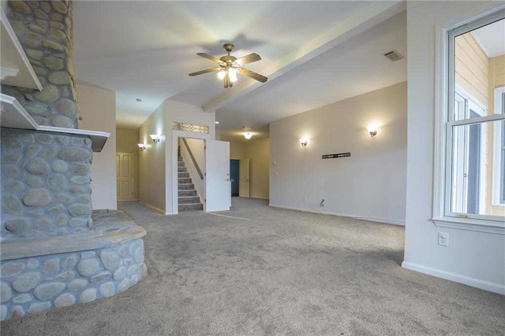 5739 Ridgewater Circle Gainesville, GA 30506 - Photo 59 of 93 an empty room with a chandelier fan and windows