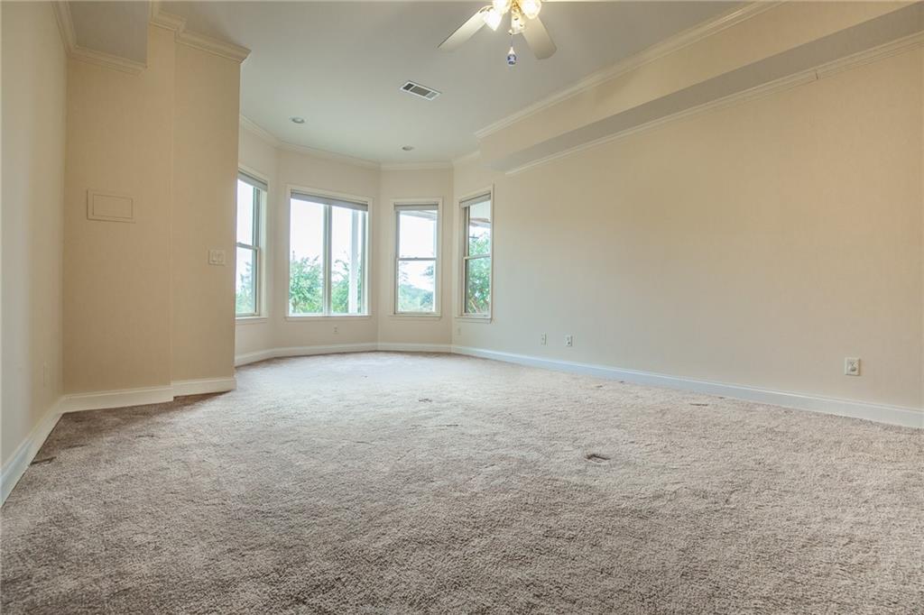5739 Ridgewater Circle Gainesville, GA 30506 - Photo 63 of 93 an empty room with windows and chandelier fan