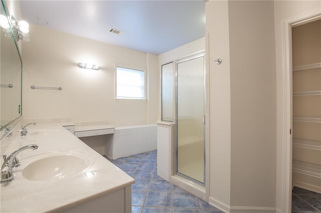 5739 Ridgewater Circle Gainesville, GA 30506 - Photo 70 of 93 a bathroom with a tub sink and mirror