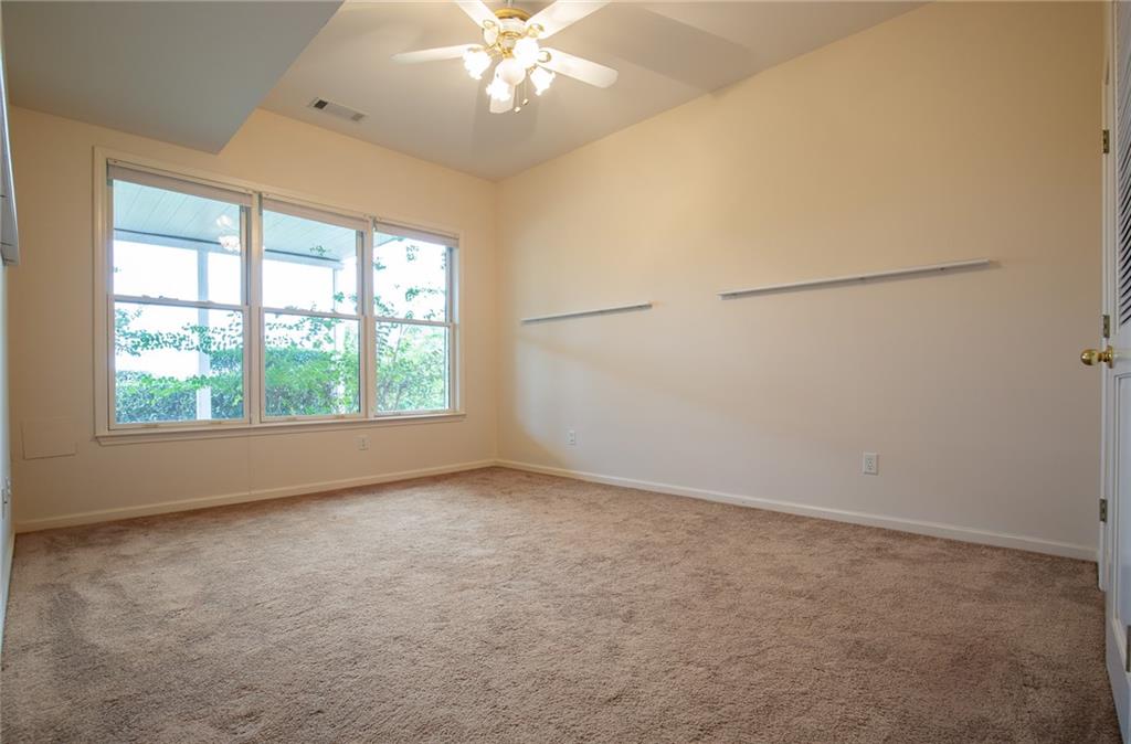 5739 Ridgewater Circle Gainesville, GA 30506 - Photo 72 of 93 an empty room with a chandelier fan and windows