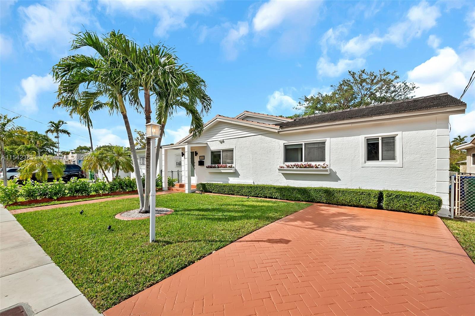 2521 Southwest 25th Terrace Miami, FL 33133 - Photo 1 of 26 a front view of a house with a yard and potted plants