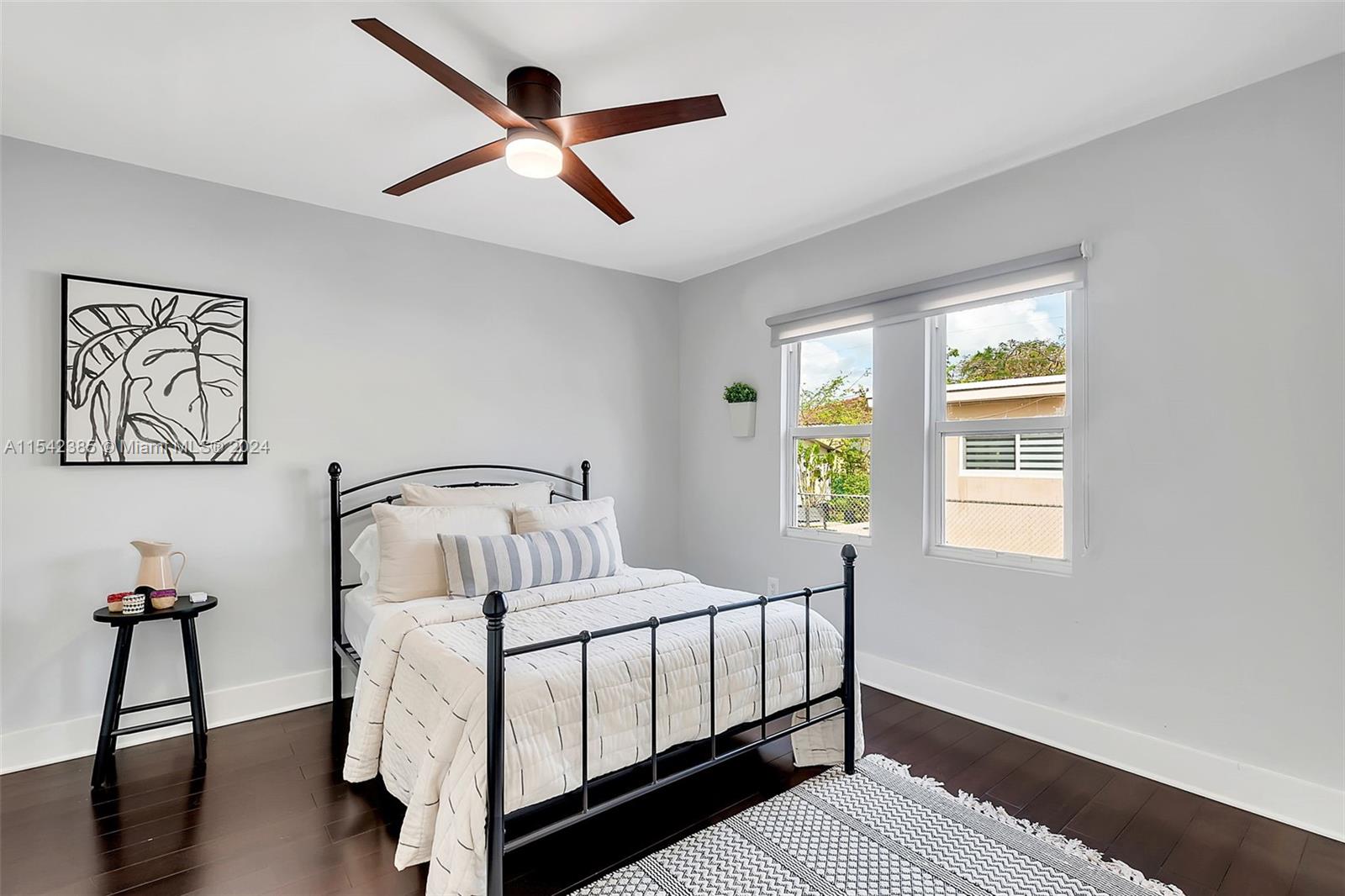 2521 Southwest 25th Terrace Miami, FL 33133 - Photo 12 of 26 a bedroom with a bed and a chandelier