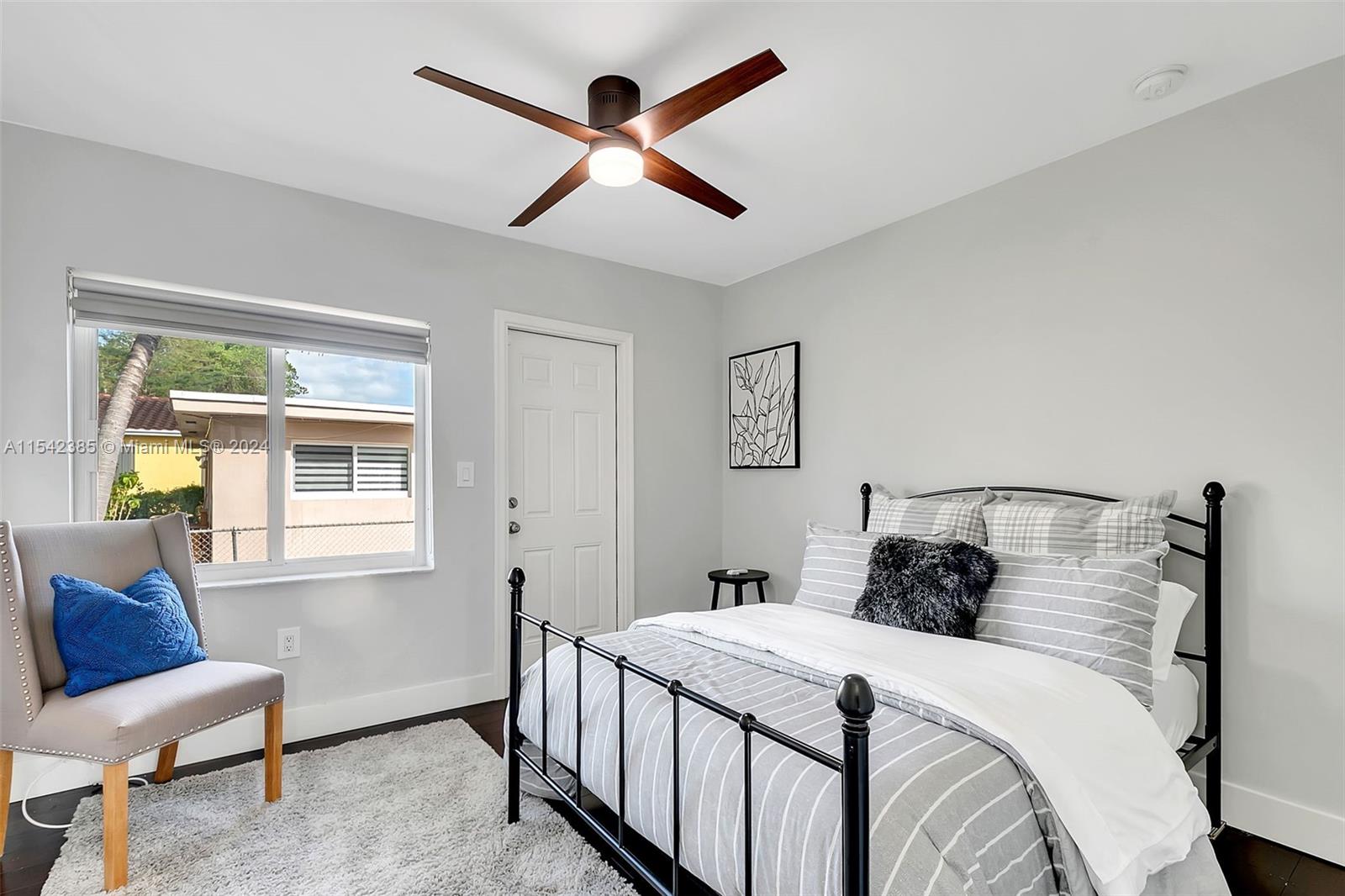 2521 Southwest 25th Terrace Miami, FL 33133 - Photo 13 of 26 a bedroom with a bed a couch and a window