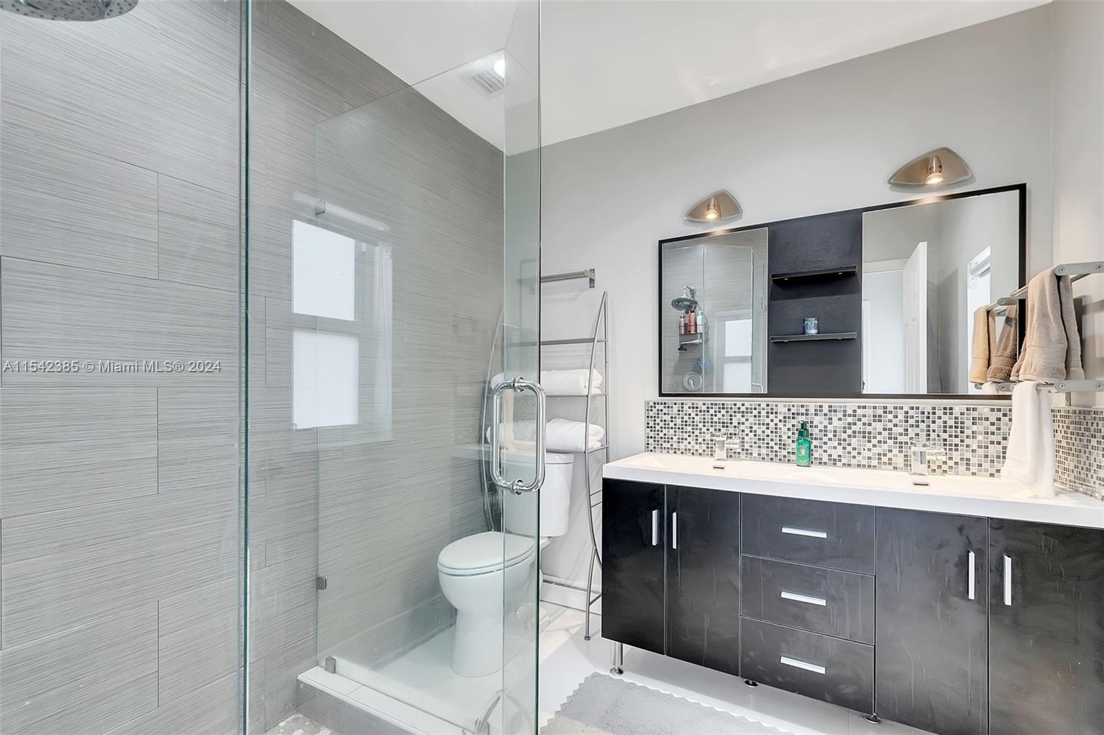 2521 Southwest 25th Terrace Miami, FL 33133 - Photo 15 of 26 a bathroom with a sink toilet and mirror