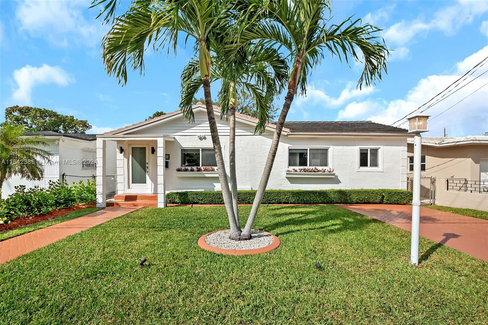 2521 Southwest 25th Terrace Miami, FL 33133 - Photo 2 of 26 a front view of a house with garden and yard