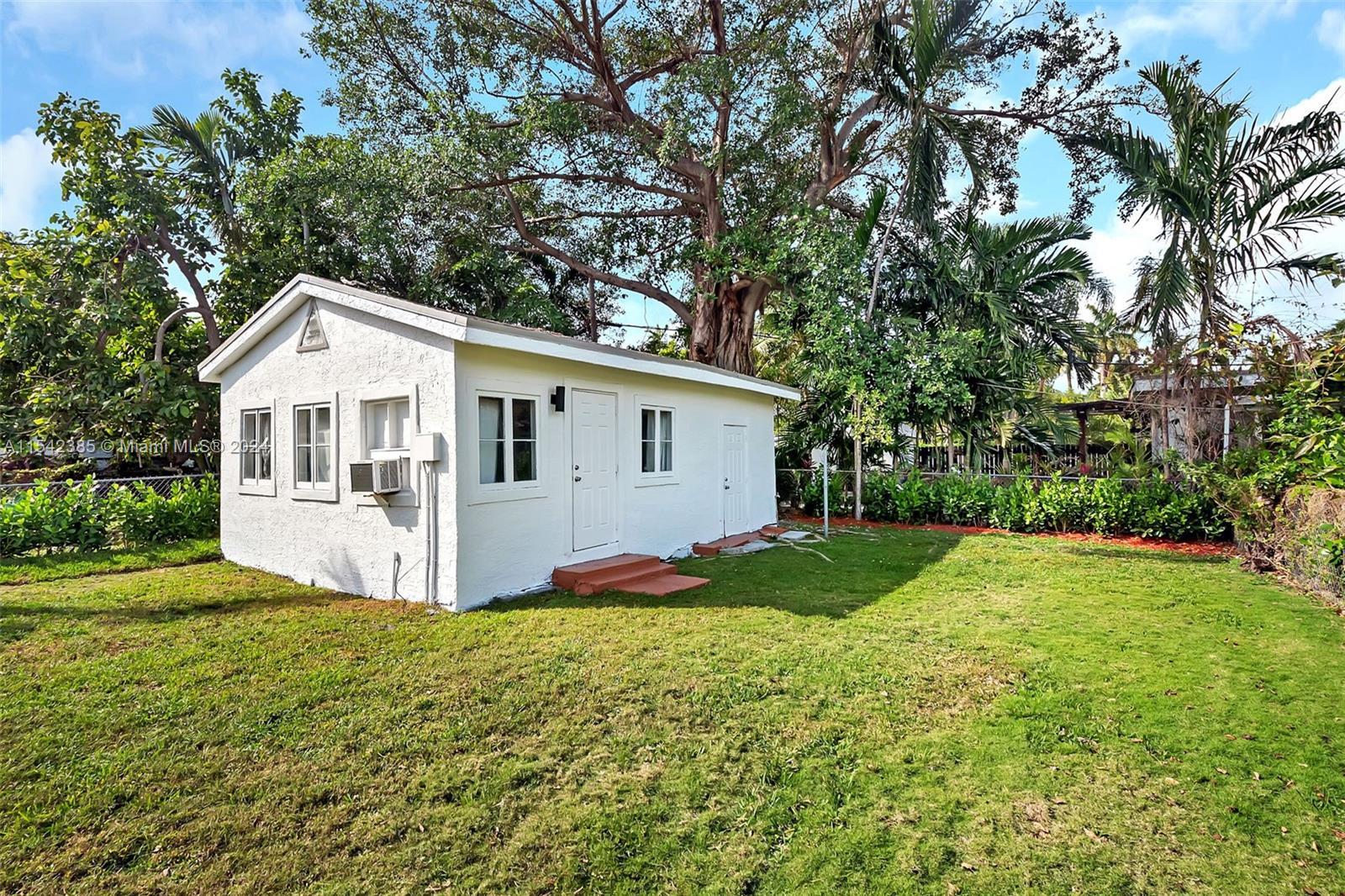 2521 Southwest 25th Terrace Miami, FL 33133 - Photo 22 of 26 a front view of house with yard and green space