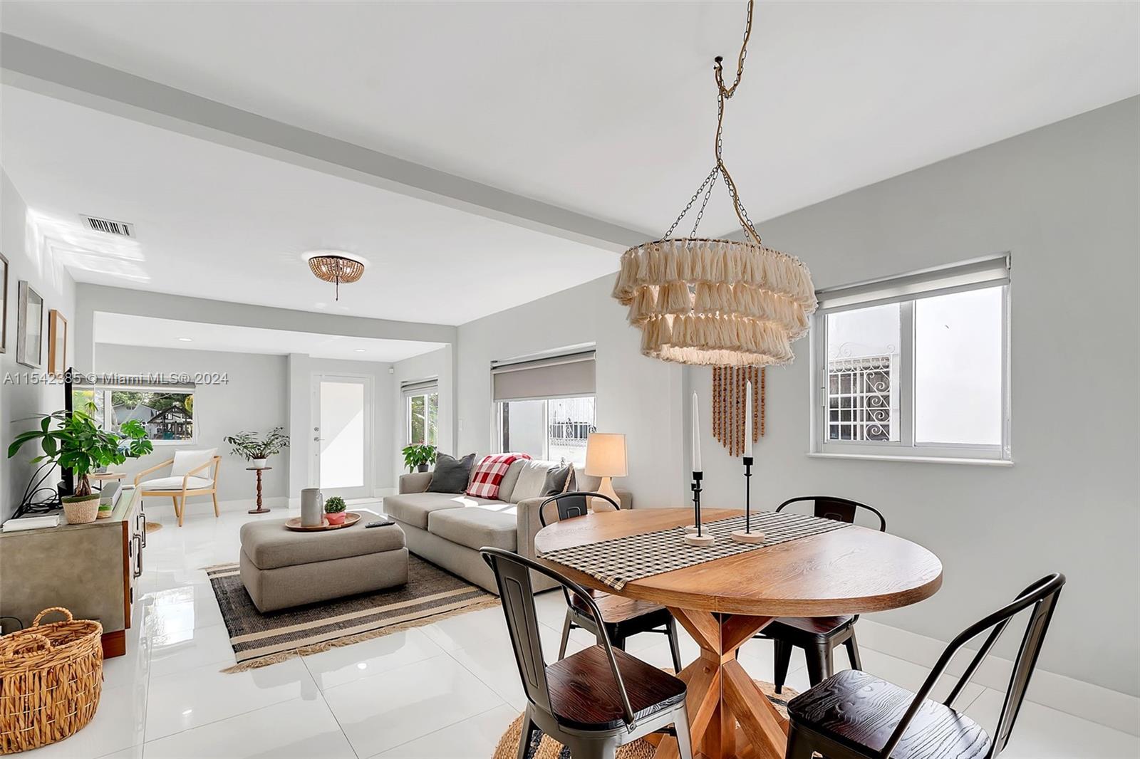 2521 Southwest 25th Terrace Miami, FL 33133 - Photo 3 of 26 a living room with furniture a chandelier and a window