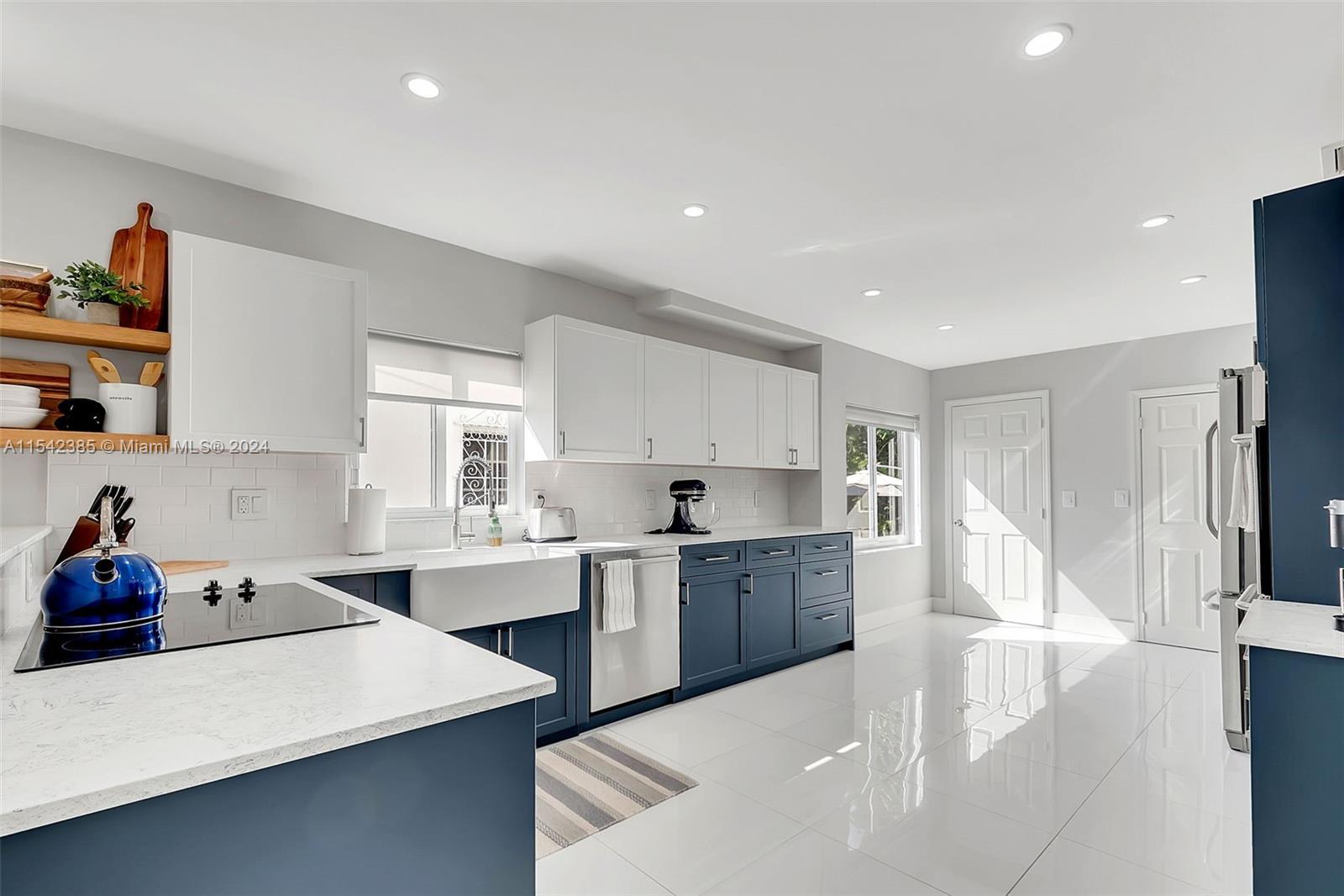 2521 Southwest 25th Terrace Miami, FL 33133 - Photo 8 of 26 a large white kitchen with sink and cabinets