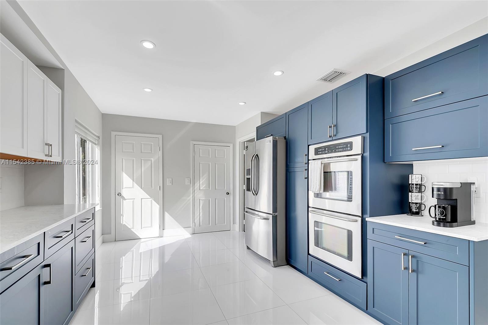 2521 Southwest 25th Terrace Miami, FL 33133 - Photo 9 of 26 a kitchen with cabinets and stainless steel appliances