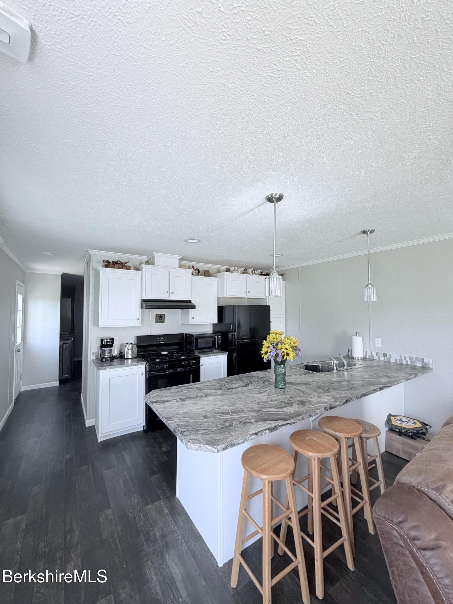 29 4th Avenue Cheshire, MA 01225 - Photo 3 of 13 a kitchen with sink and chairs