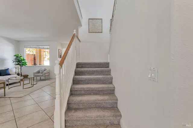 a living room with furniture a chandelier and a table