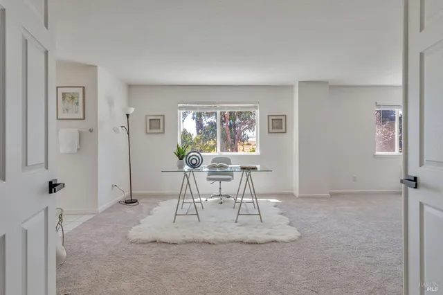 a spacious bedroom with a bed and a ceiling fan