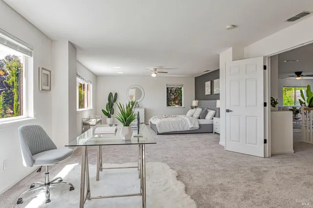 a bed sitting in a bedroom next to a window