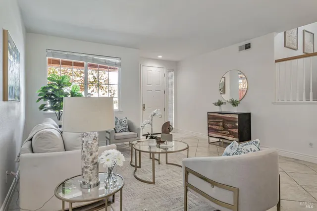 a living room with furniture a large window and a fireplace
