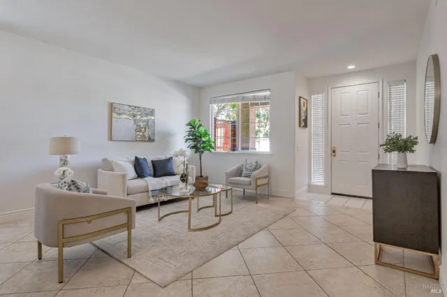 a kitchen with a sink a stove a refrigerator and white cabinets