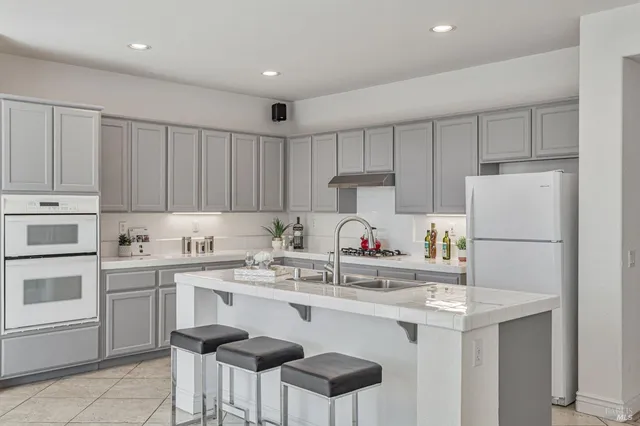 a living room with furniture and flowers