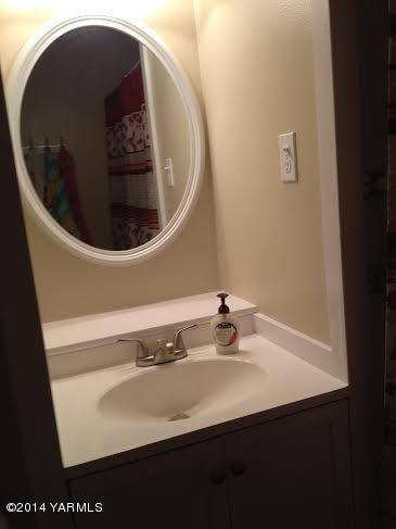 910 Willowlawn Road Yakima, WA 98908 - Photo 29 of 39 a close view of a sink and a mirror