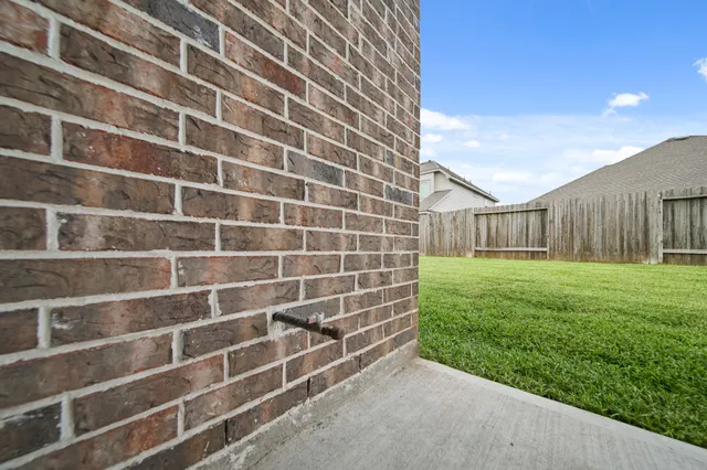 a view of a house with backyard and porch