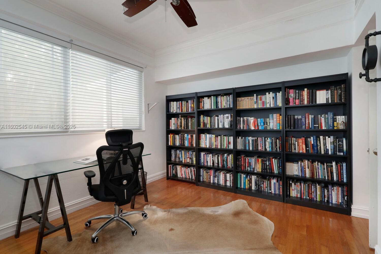 84 Shore Drive West Coconut Grove, FL 33133 - Photo 11 of 21 a view of a workspace with furniture and a bookshelf