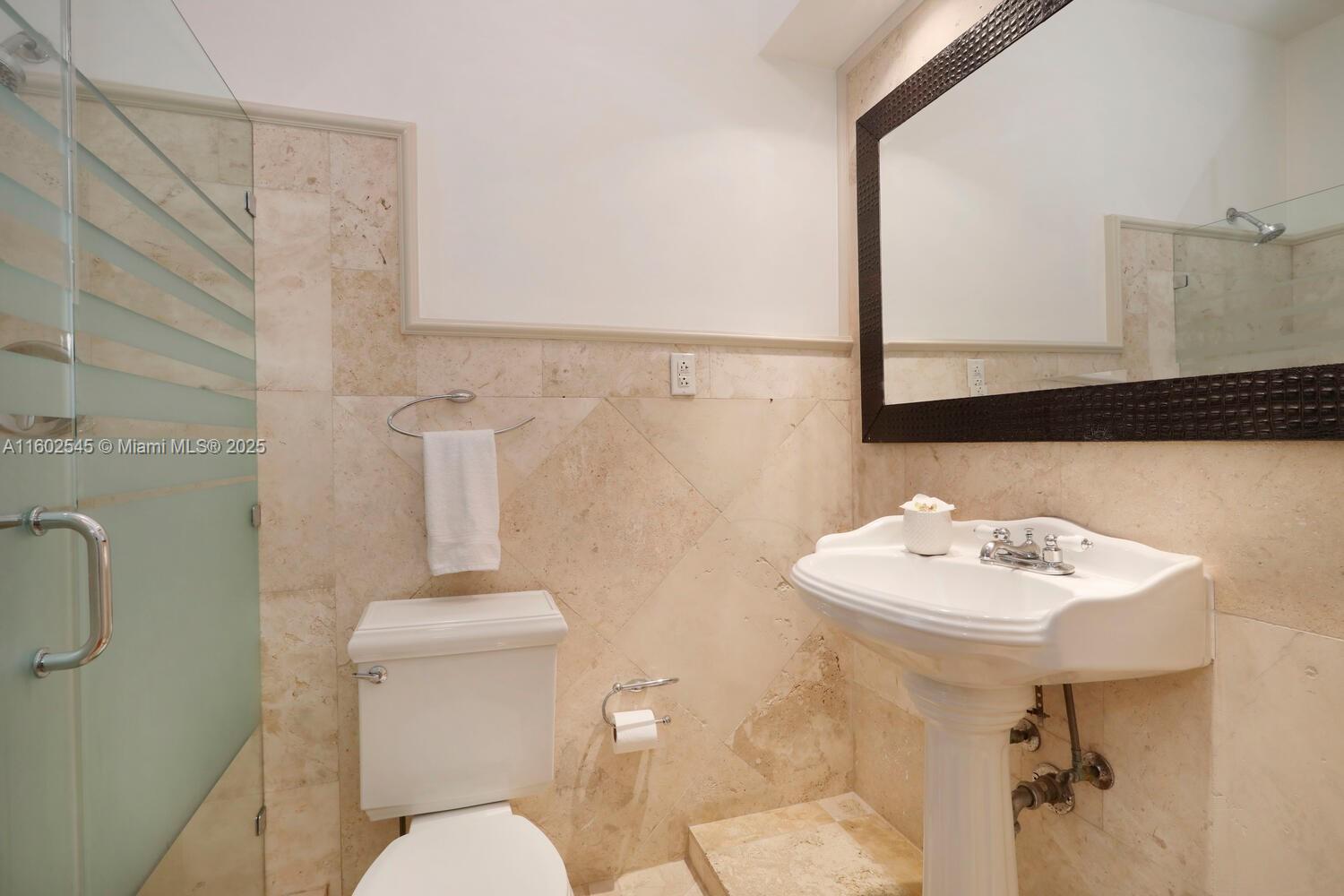 84 Shore Drive West Coconut Grove, FL 33133 - Photo 12 of 21 a bathroom with a sink mirror and toilet