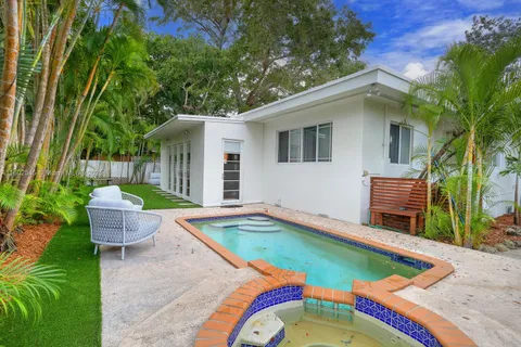 a view of a backyard with swimming pool