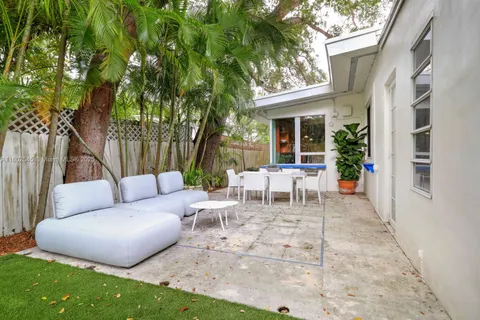 a view of a patio with table and chairs and potted plants