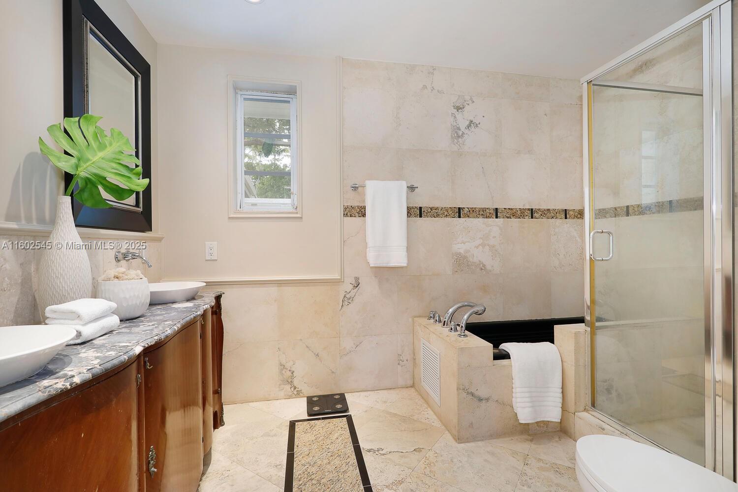 84 Shore Drive West Coconut Grove, FL 33133 - Photo 8 of 21 a bathroom with a granite countertop sink a toilet and shower