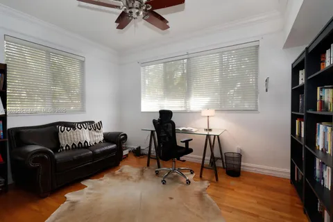 a view of a livingroom with workspace and a window