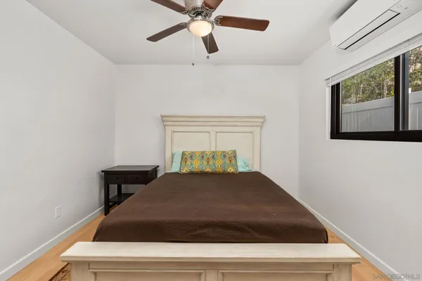 a bedroom with a bed and a window