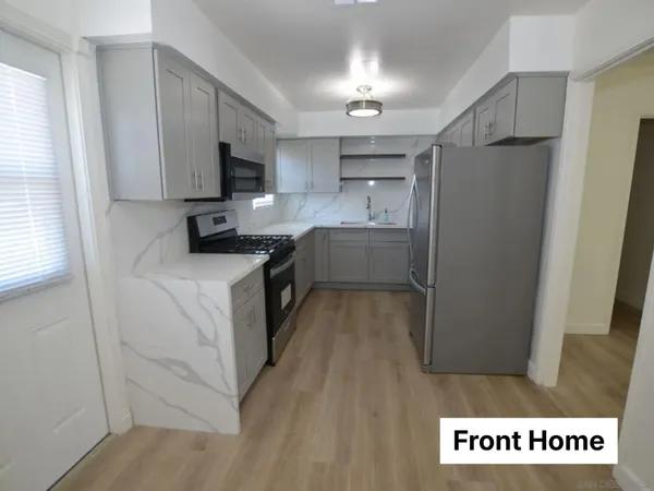 a kitchen with cabinets and stainless steel appliances