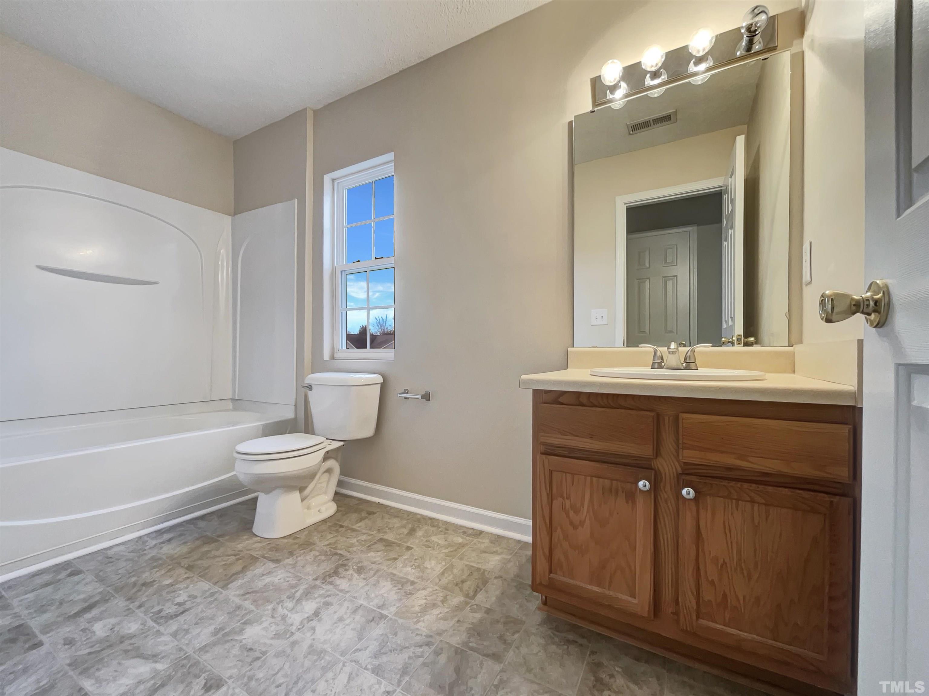 6036 Namozine Court Raleigh, NC 27610 - Photo 14 of 19 a bathroom with a sink a toilet and mirror