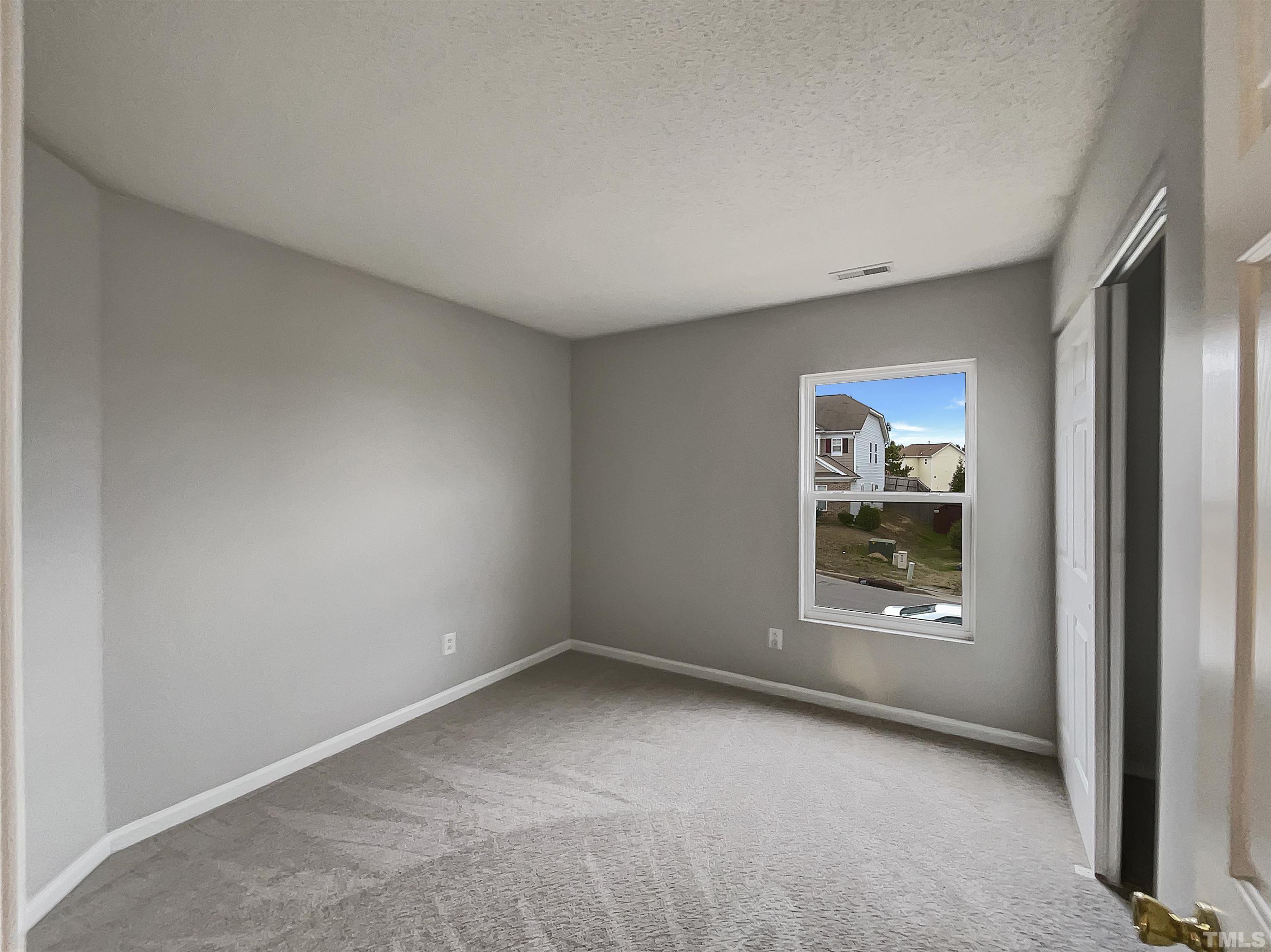 6036 Namozine Court Raleigh, NC 27610 - Photo 16 of 19 an empty room with windows and closet
